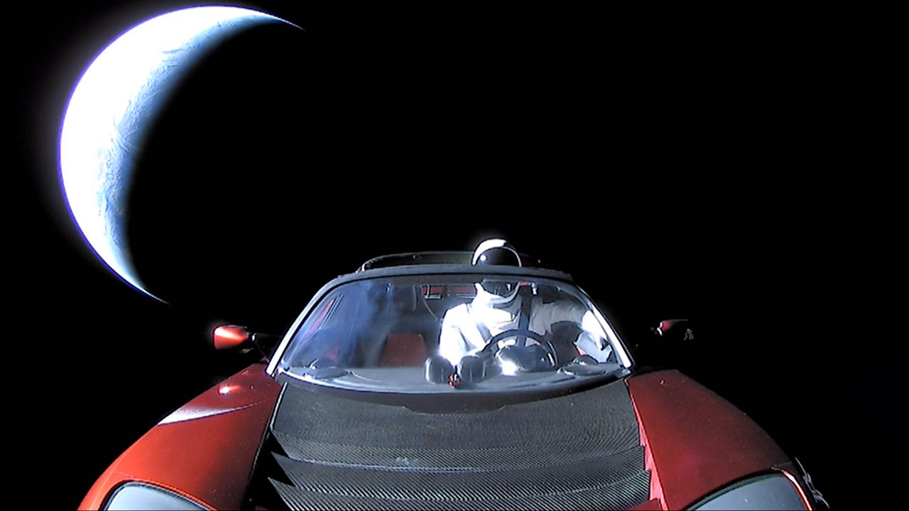 Starman in a Tesla Roadster with Earth behind it